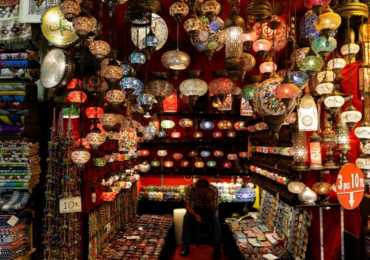 A shopkeeper waits for customers at the Grand Bazaar, known as the Covered Bazaar, in Istanbul